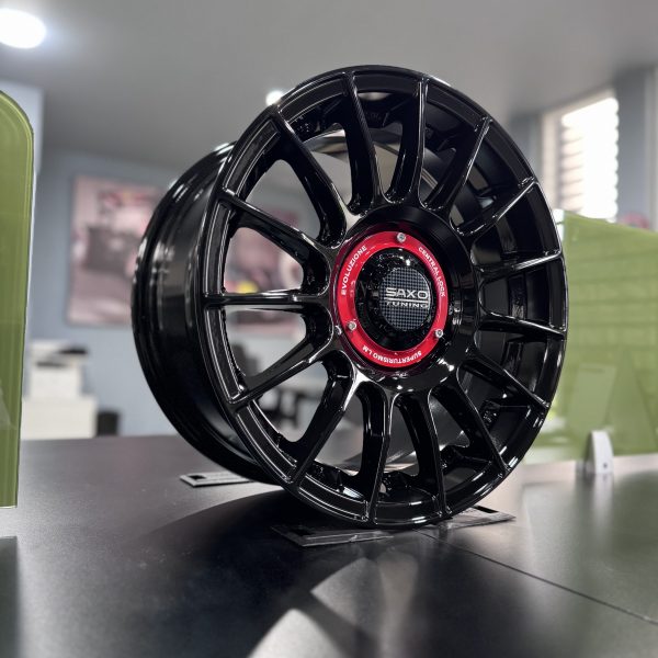 Rines r15x7 4x100 4x114.3 2259 Saxo Gloss Black - Imagen 4