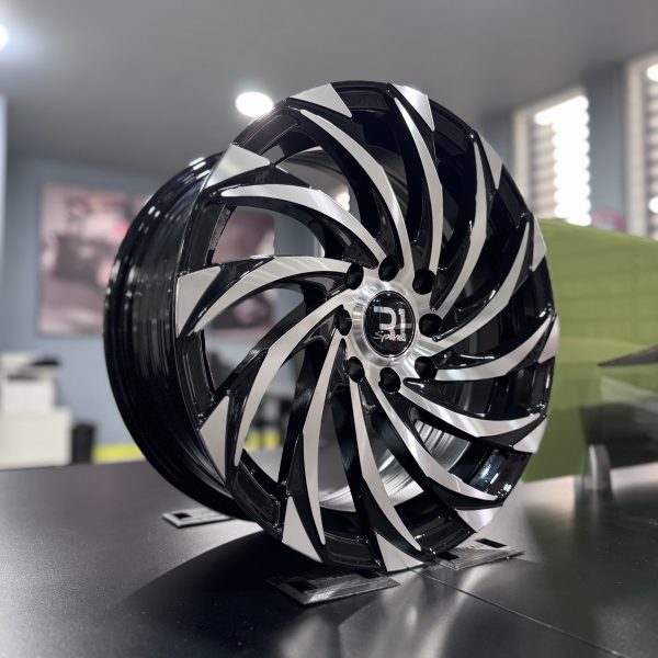 Rines r15x6.5 4x100 4x114.3 10702 R1 Black Machine Face - Imagen 4